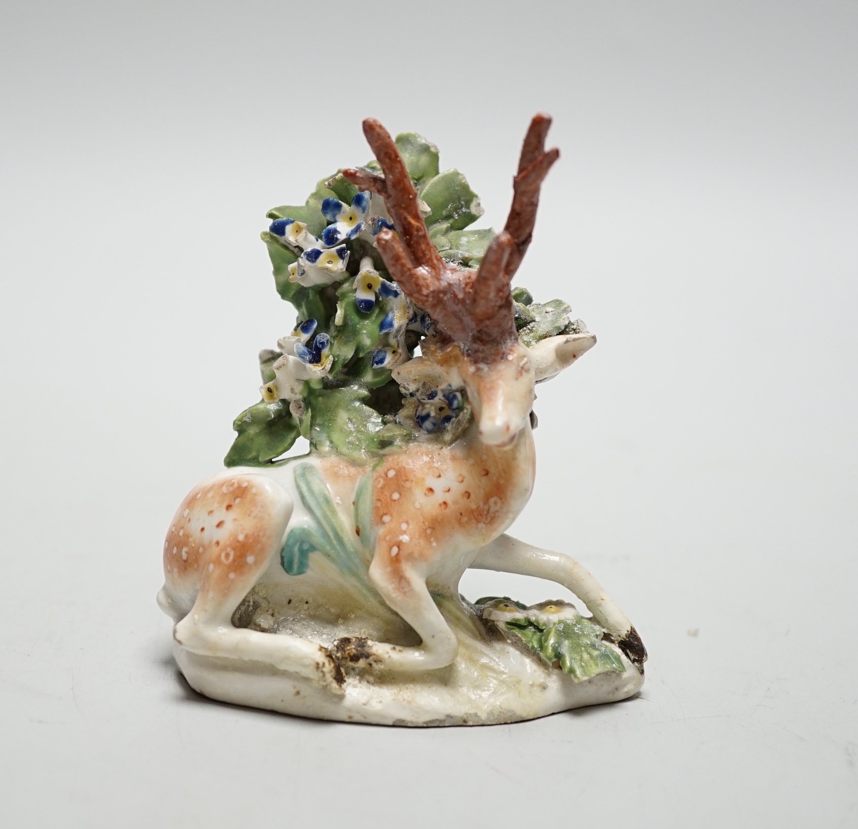 A Derby figure of a recumbent deer and bocage, c.1765, 10cm